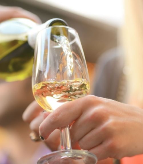 Person pouring champagne into glass at Castle Hill Inn in Newport, RI